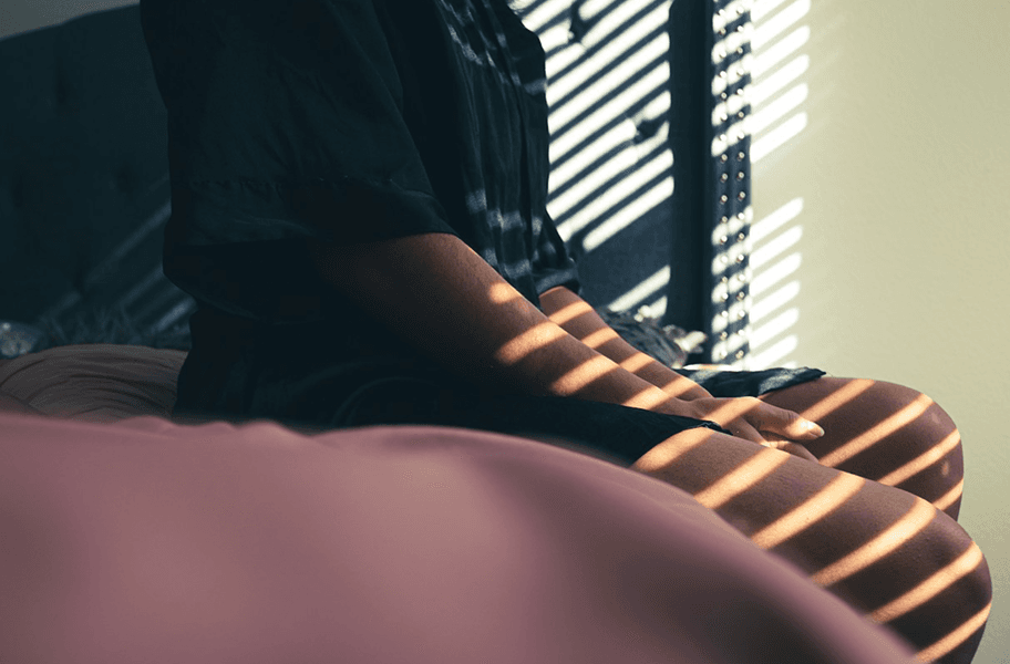 Woman sitting on a bed