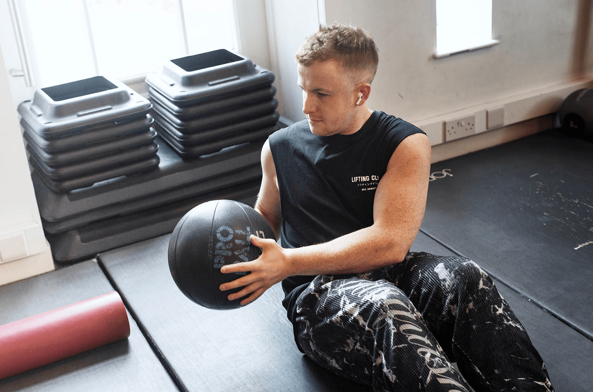 Man exercising with a medicine ball in a gym